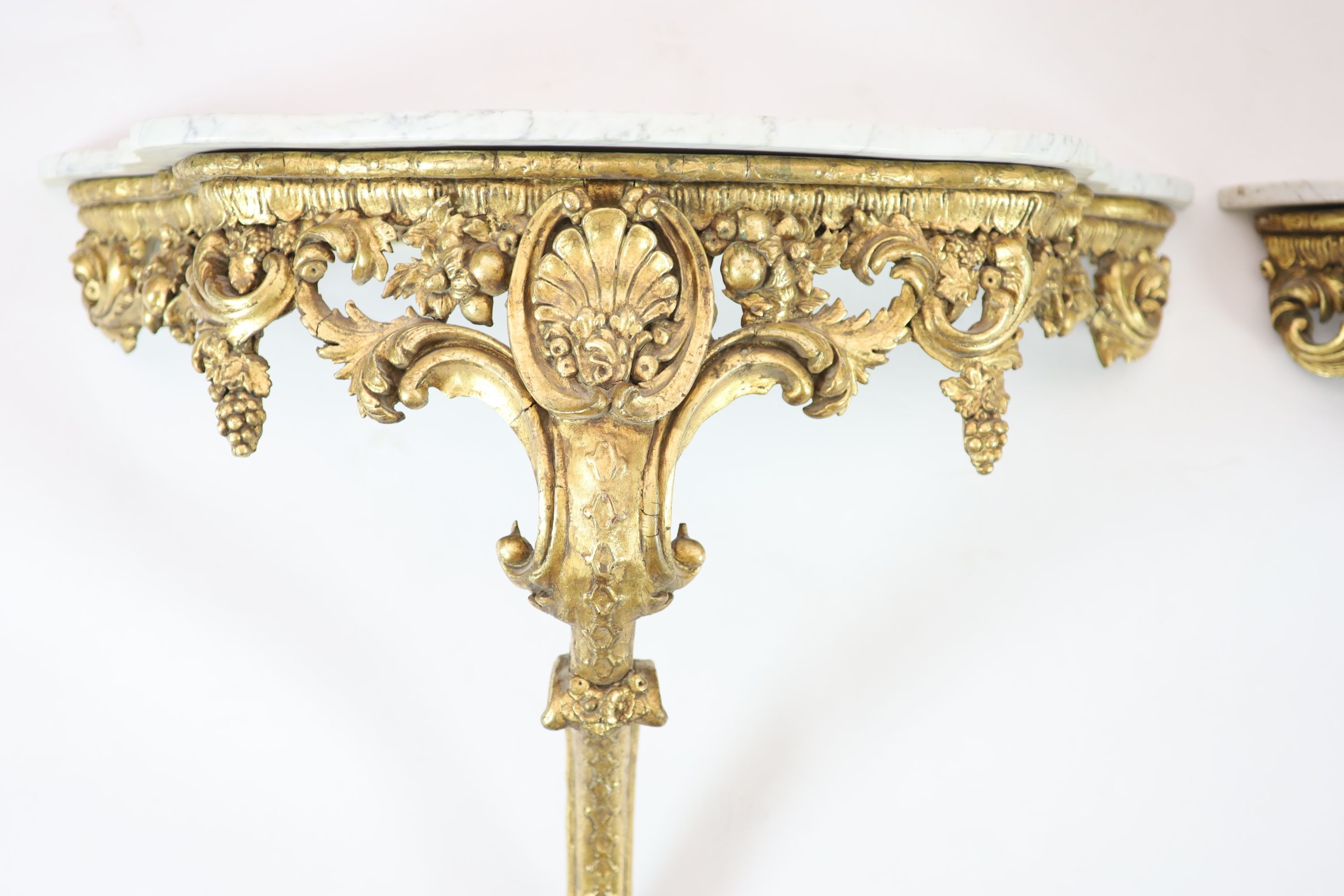 A pair of Louis XV style carved giltwood console tables H 84cm. W 98cm. D 42cm.